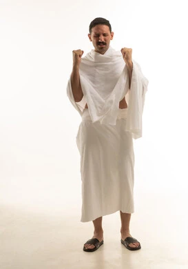 رجل سعودي بملابس الإحرام يدعو لمناسك الحج والعمرة