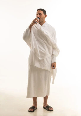 Saudi Male Pilgrim in Ihram Drinking Water