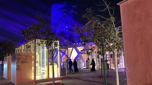 A global food experience, glass kiosks at a food festival in the Ithra outdoor gardens in Dhahran, Eastern Province, Saudi Arabia, on December 28, 2025, family-friendly and entertaining atmosphere, enjoyable outdoor seating, recreational and educational attractions, international and local restaurants.