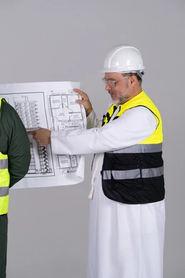 Emirati Engineer Holding Construction Blueprint in Studio