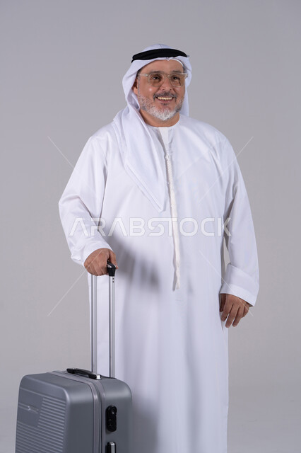 Smiling Emirati Senior Man with Suitcase Full Length