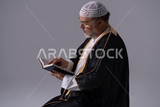 Emirati Man Reading Holy Quran in Studio