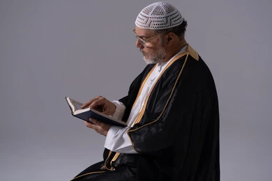 Emirati Man Reading Holy Quran in Studio