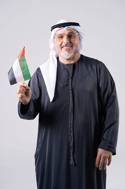 Emirati Man Holding UAE Flag on Gray Background