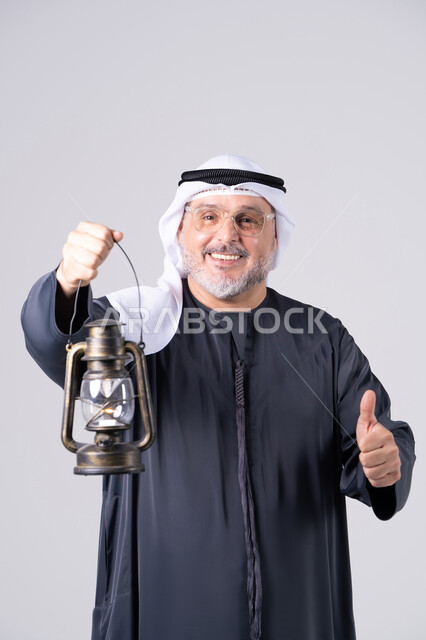 Emirati Man Holding Lantern with Thumbs Up Gesture