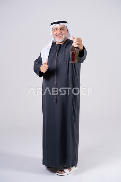 Emirati Man Holding Ramadan Lantern with Thumbs Up