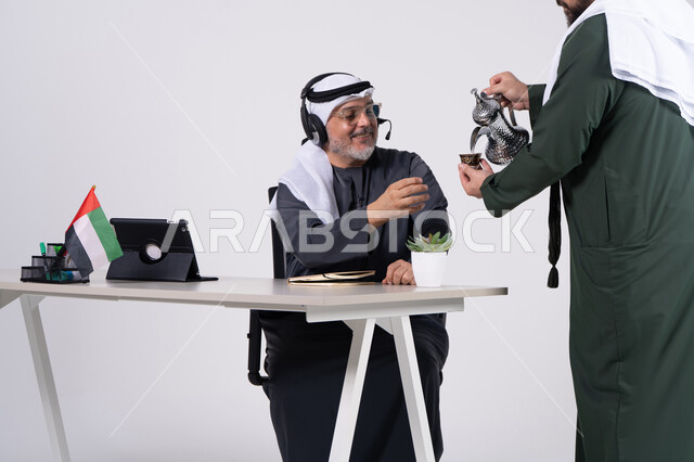 Emirati Man Receiving Traditional Coffee at Office Desk