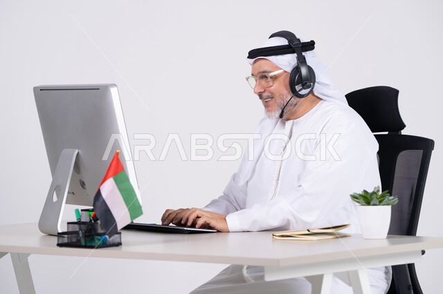 Emirati Businessman Working on Computer with Headset