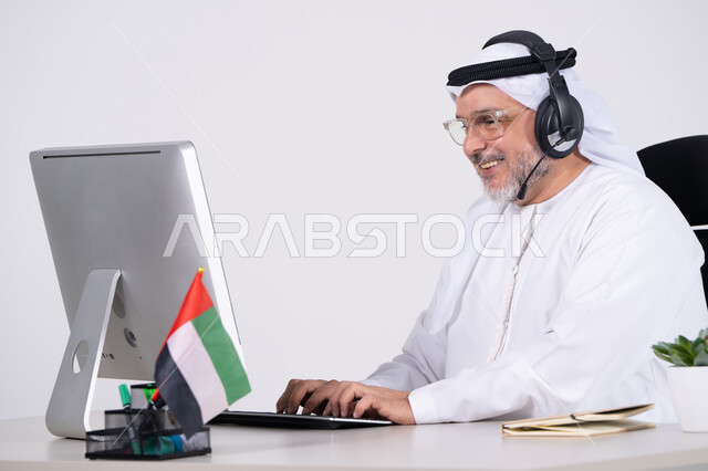 Emirati Businessman Working on Computer with Headset