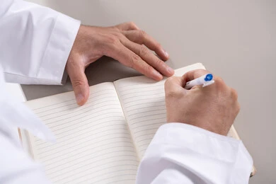 Emirati Man Writing in Notebook Close Up