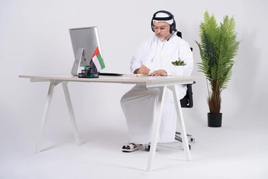 Emirati Businessman with Headset Working at Office Desk