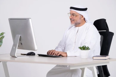 Emirati Businessman Working on Desktop Computer in Office