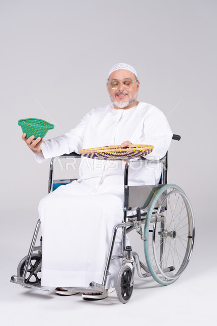 Emirati Man in Wheelchair Holding Traditional Woven Baskets