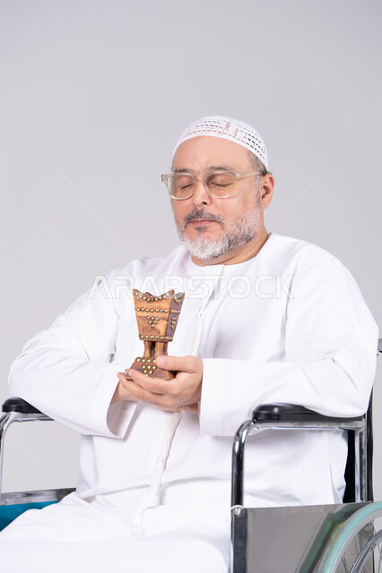 Emirati Man in Wheelchair Holding Incense Burner