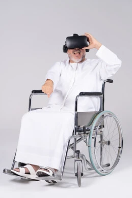 Emirati Senior Man in Wheelchair Using VR Headset