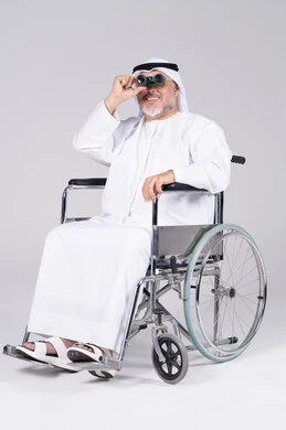 Emirati Man in Wheelchair Using Binoculars Studio