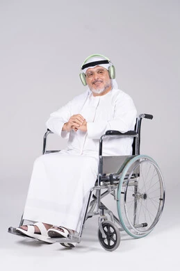 Emirati Senior Man in Wheelchair with Headphones