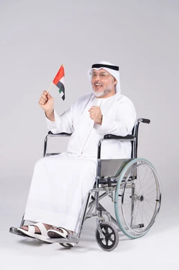 Emirati Man in Wheelchair Holding UAE Flag