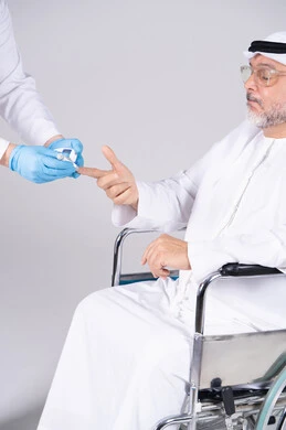 Emirati Man in Wheelchair Having Blood Glucose Test Emirati Man in Wheelchair Having Blood Glucose Test