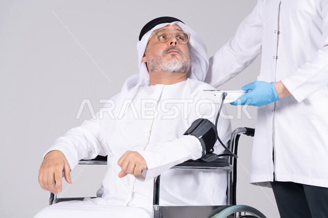 Emirati Man in Wheelchair Having Blood Pressure Checked