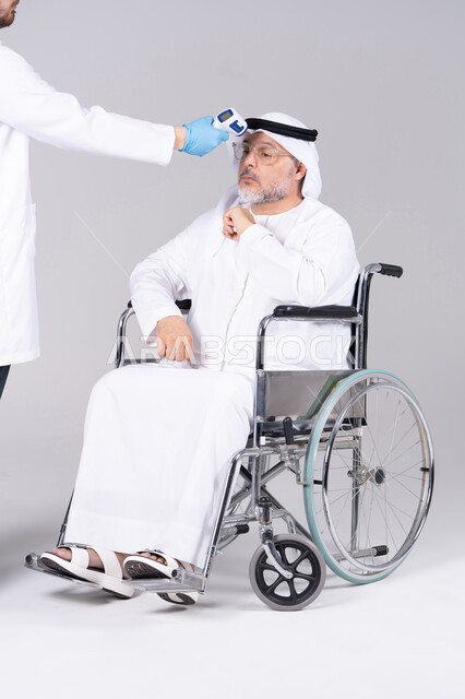 Emirati Senior in Wheelchair Having Temperature Checked
