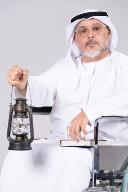 Elderly Emirati Man in Wheelchair Holding Lantern