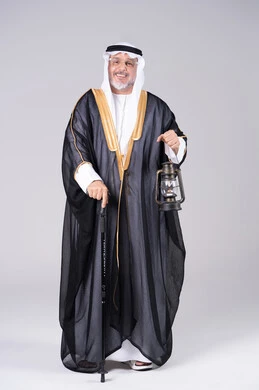 Elderly Emirati Man in Traditional Bisht with Lantern