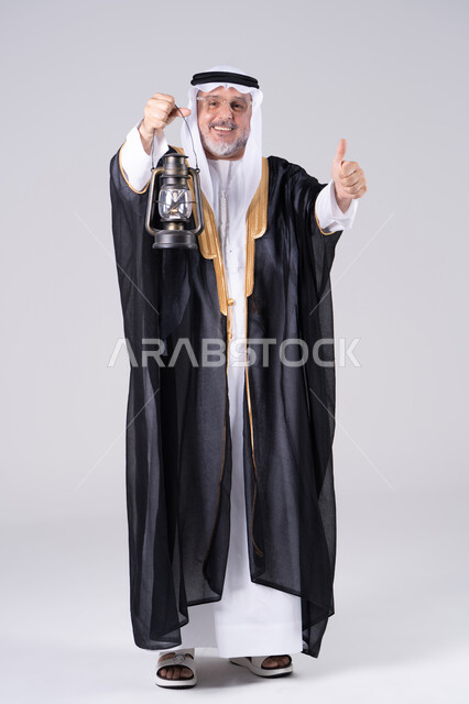 Emirati Man in Traditional Bisht Holding Lantern Thumbs Up