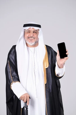 Emirati Senior Man in Traditional Dress Holding Smartphone