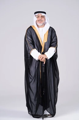رجل إماراتي بالبشت الأسود والزي التقليدي بخلفية بيضاء
