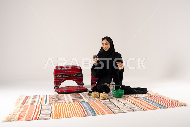 Saudi Woman Using Smartphone in Traditional Setting