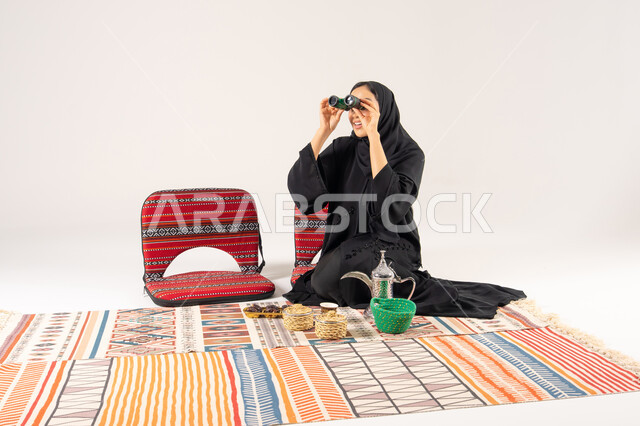Saudi Woman in Abaya with Binoculars and Coffee