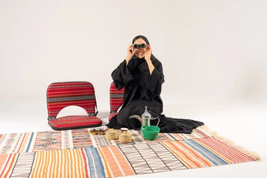 Saudi Woman with Binoculars and Traditional Camping Gear