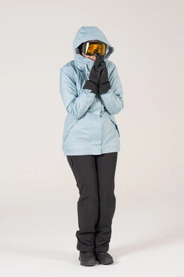 امرأة بملابس التزلج الشتوية ترتجف بخلفية بيضاء