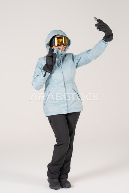 Saudi Woman in Ski Gear Taking Selfie