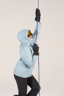 امرأة سعودية بملابس رياضية شتوية تتسلق حبلاً