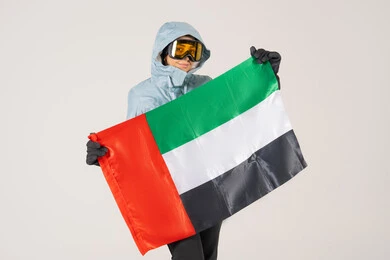Woman in Winter Ski Gear Holding UAE Flag