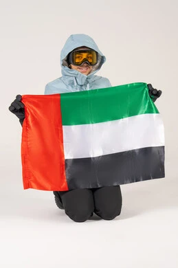 Emirati Man in Winter Ski Gear Holding UAE Flag