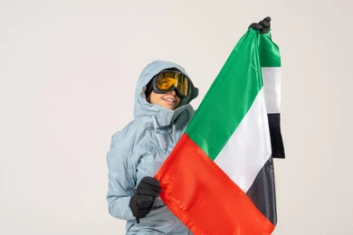 Emirati Woman in Winter Ski Gear with UAE Flag