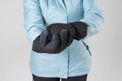 Person Adjusting Black Winter Gloves in Blue Jacket