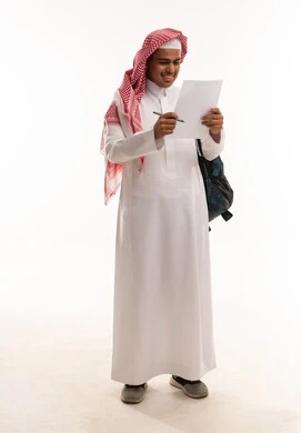 Saudi Student in Traditional Thobe Reading Document