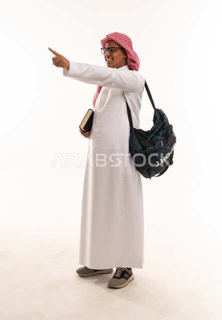 Saudi Male Student with Backpack and Book Pointing