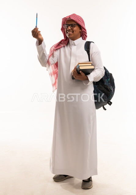 Saudi Student in Traditional Thobe with Books and Pen