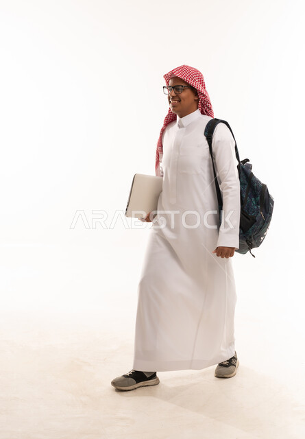 Saudi Student Walking with Laptop and Backpack