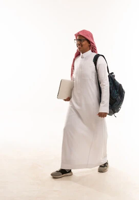 Saudi Student Walking with Laptop and Backpack