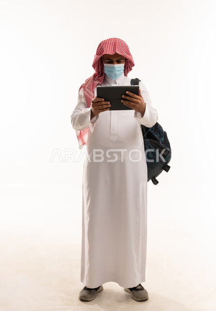 Saudi Man with Tablet and Face Mask Studio Shot