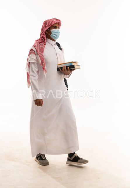 Saudi Student in Mask Carrying Books on White Background
