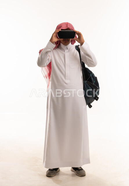 Saudi Man in Thobe Using VR Headset on White Background