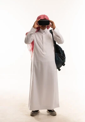 Saudi Man in Thobe Using VR Headset on White Background