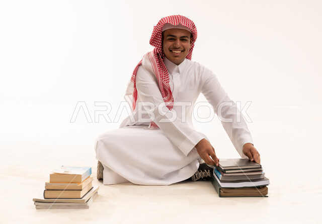 Saudi Student in Traditional Dress with Books